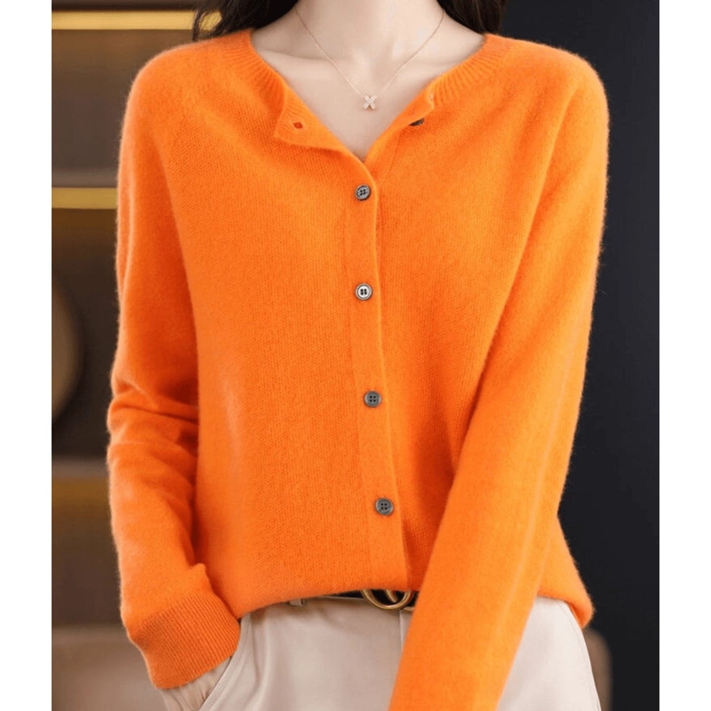 An orange cashmere V-neck cardigan for women, featuring long sleeves and button closure, designed for winter wear, displayed in a 2XL size.