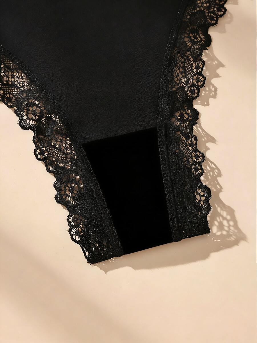 Conjunto de 5 calcinhas fio dental pretas de algodão com detalhes em renda e laço delicado. Modelo minimalista sem costura.