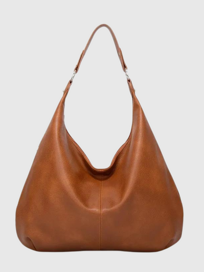 Brun læderhåndtaske med enkelt skulderrem, minimalistisk design. Perfekt til hverdagsbrug. Stilfuld og praktisk accessory til kvinder.