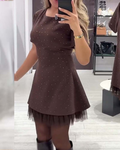 Elegant dress with a shimmering, mesh patchwork pattern