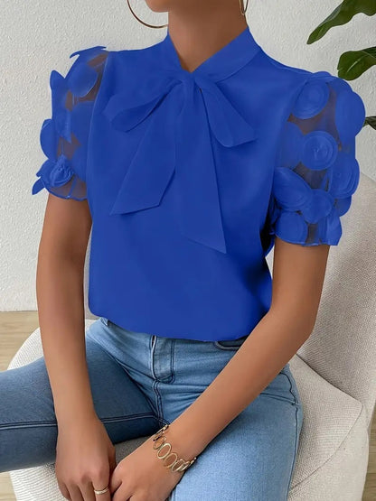 Elegancka damska bluzka z kokardą i przezroczystymi rękawami