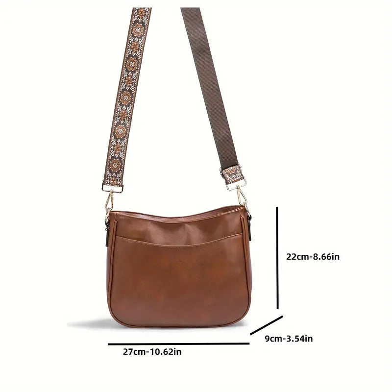 Sac bandoulière en cuir marron avec sangle ajustable à motifs, dimensions 27x22x9 cm. Accessoire mode élégant et pratique pour femme.