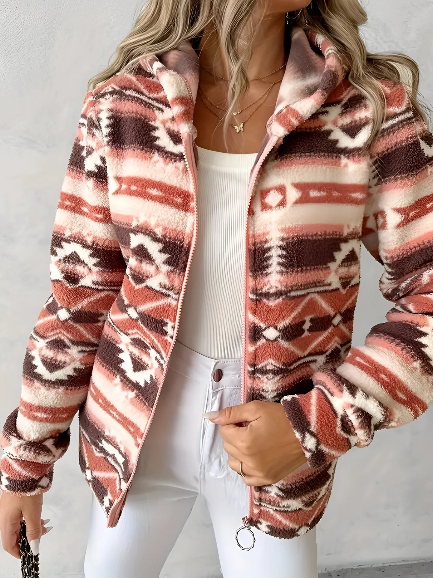 Cozy Women's Southwestern Plush Fleece Zip-Up Jacket in red orange, size XL, showcasing a soft fleece texture with a collar and long sleeves. The image emphasizes fashionable design details such as the neckline and the zip-up front, with the jacket being worn by a model.