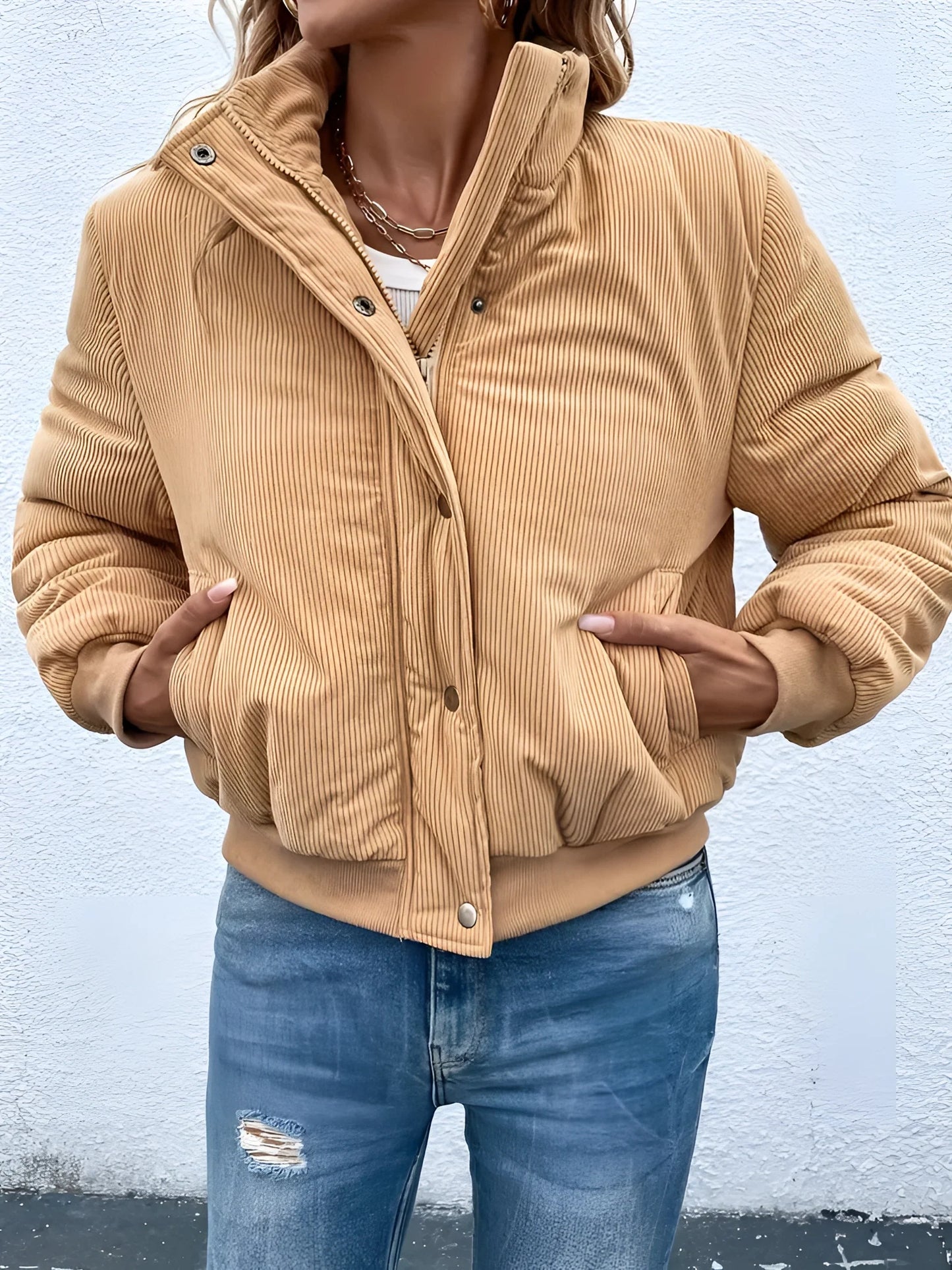 Tan corduroy bomber jacket for women displayed on a white background, showcasing its trendy fall style with a classic design featuring long sleeves and a comfortable fit.