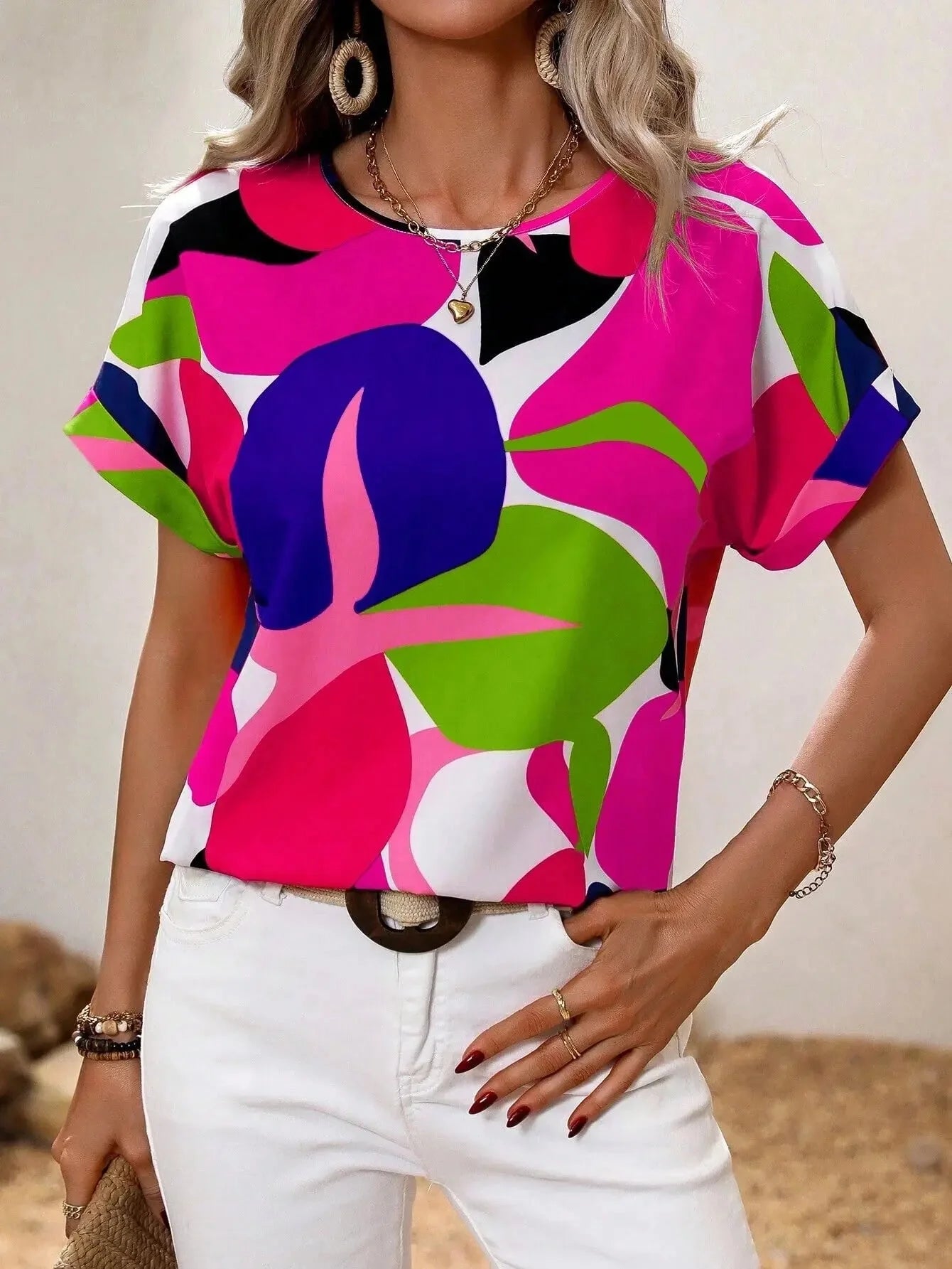 
A women's short sleeve summer blouse with a green leaf print design, shown in a pink color variant, size 2XL. The blouse features a round neck and a relaxed fit, ideal for casual fashion wear.