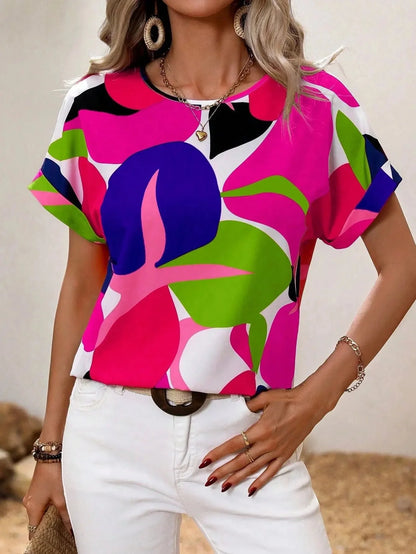 
A women's short sleeve summer blouse with a green leaf print design, shown in a pink color variant, size 2XL. The blouse features a round neck and a relaxed fit, ideal for casual fashion wear.