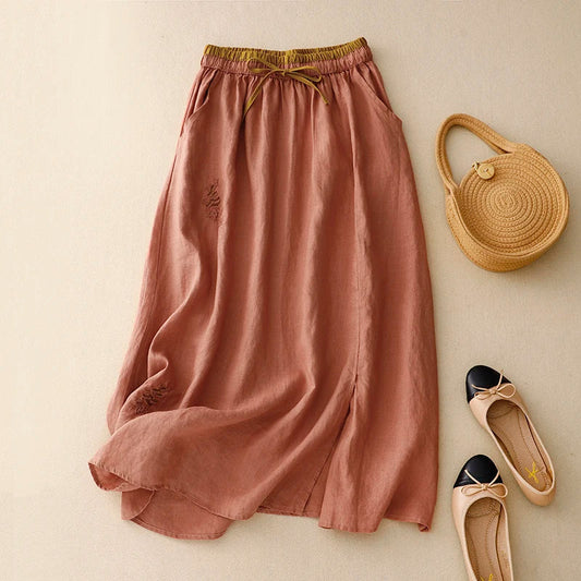 Light blue linen skirt with a relaxed fit and a flowy style, perfect for casual summer outings. 0