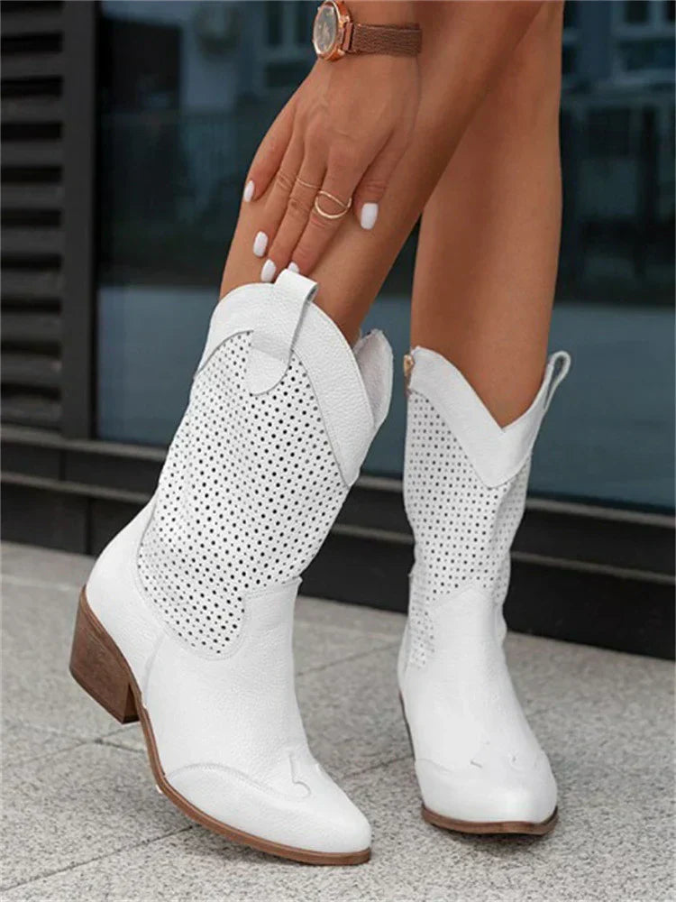 A pair of women's heeled cowboy boots featuring a cut-out design and a side zipper for easy wear. 1
