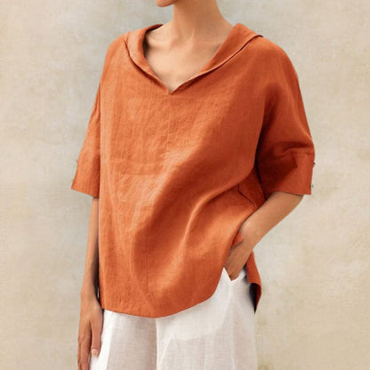 Loose women's top with a V-neck design, suitable for spring, featuring a relaxed fit and stylish silhouette. 1