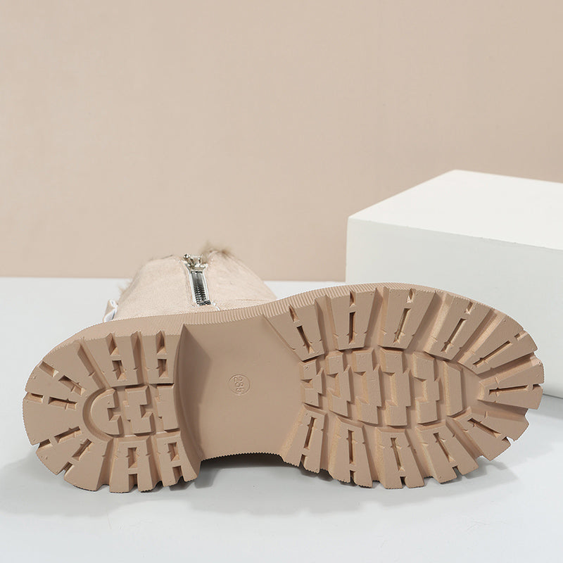 Semelle de botte beige avec crampons antidérapants, vue de dessous. Chaussure d'hiver tendance, idéale pour la mode et le confort par temps froid.