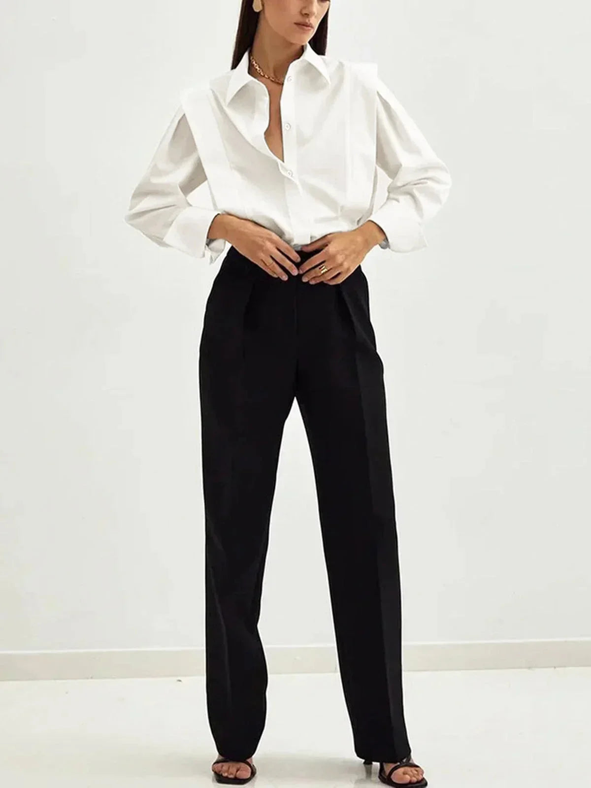 Women's white oversized shirt with structured shoulders and V-neck