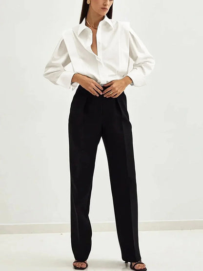Women's white oversized shirt with structured shoulders and V-neck