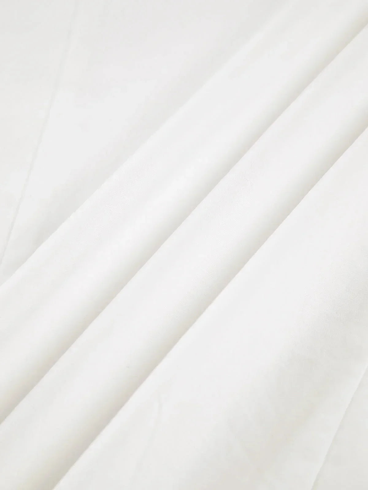 Women's white oversized shirt with structured shoulders and V-neck