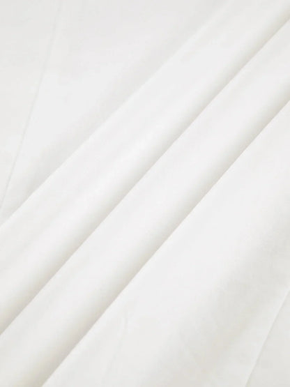 Women's white oversized shirt with structured shoulders and V-neck