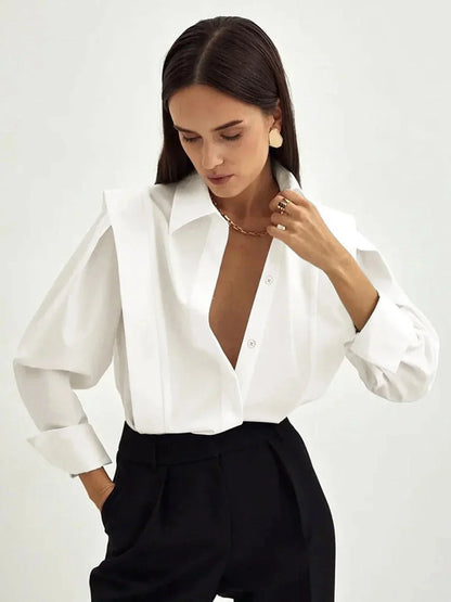 Women's white oversized shirt with structured shoulders and V-neck