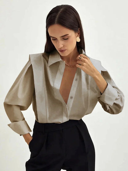 Women's white oversized shirt with structured shoulders and V-neck