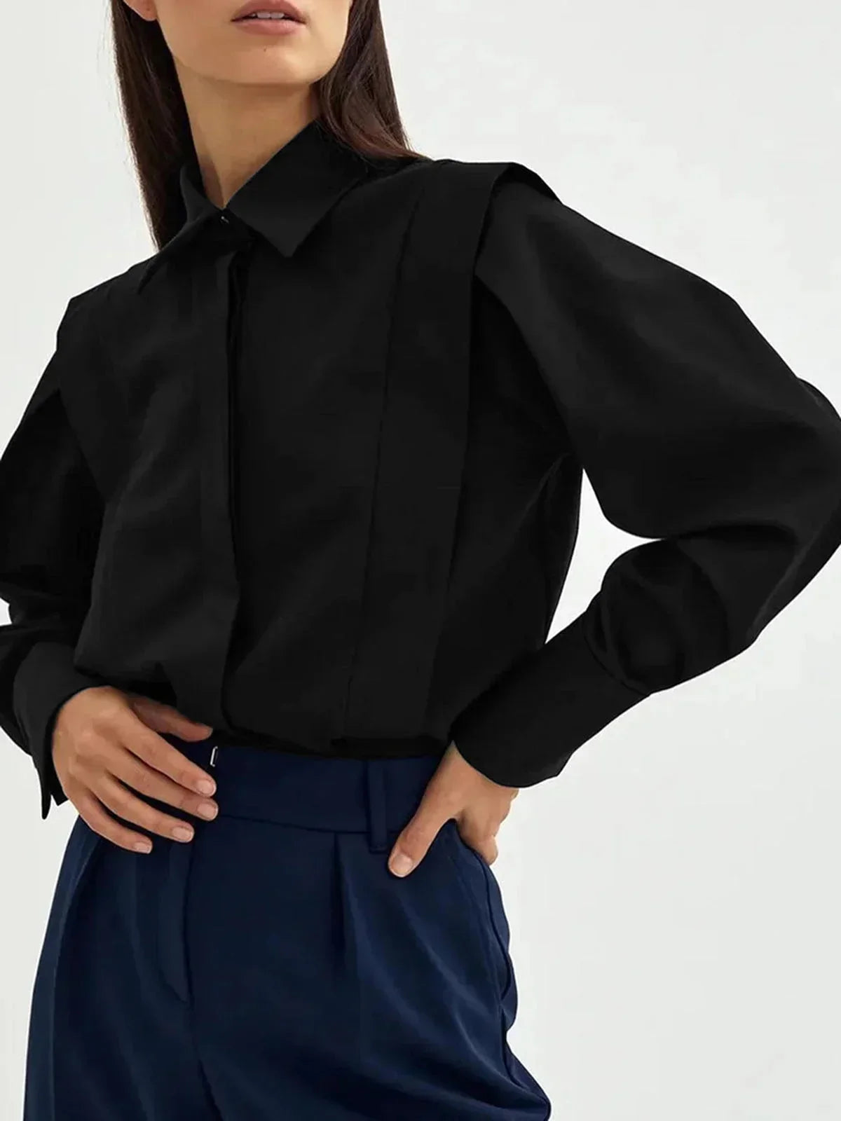 Women's white oversized shirt with structured shoulders and V-neck