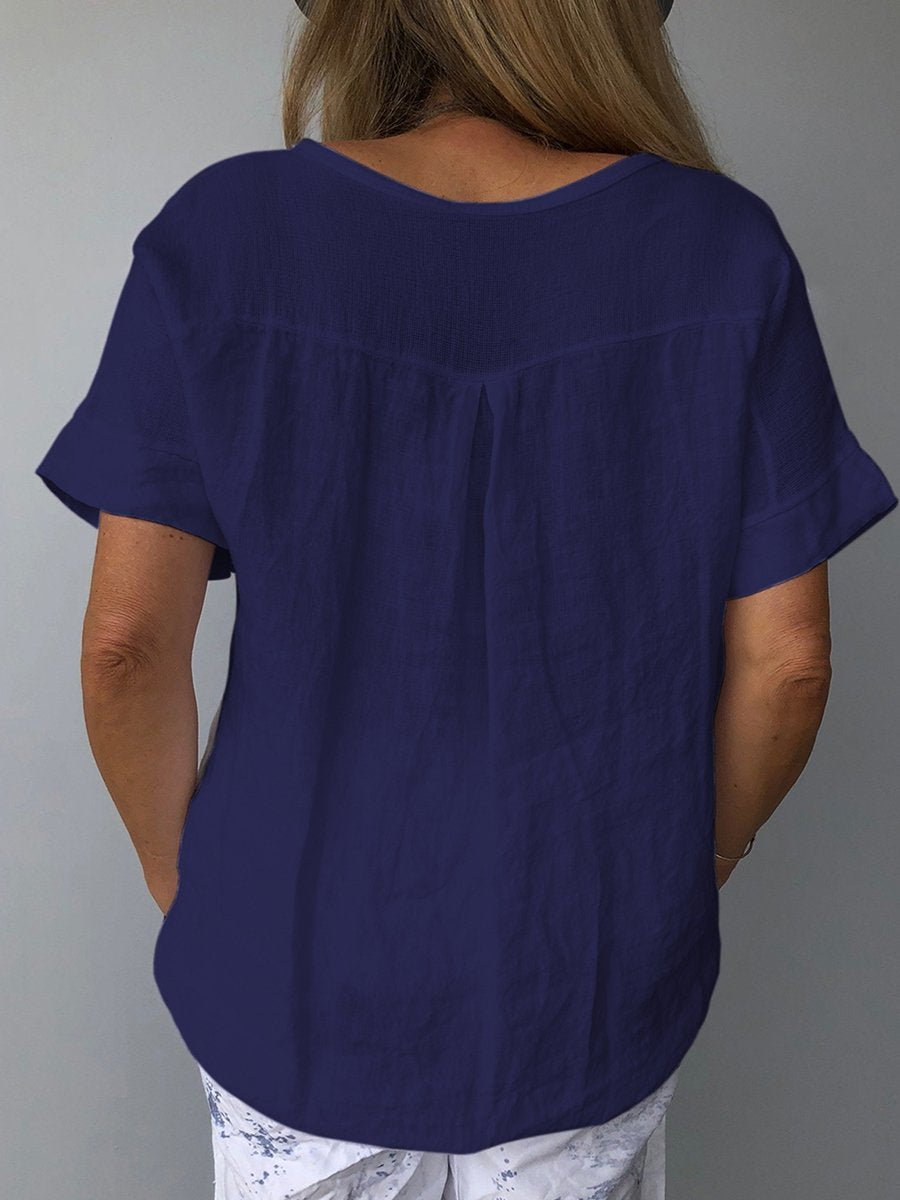 Femme portant un t-shirt bleu marine en lin, manches courtes, coupe décontractée, dos visible. Mode estivale, tenue décontractée, style confortable.