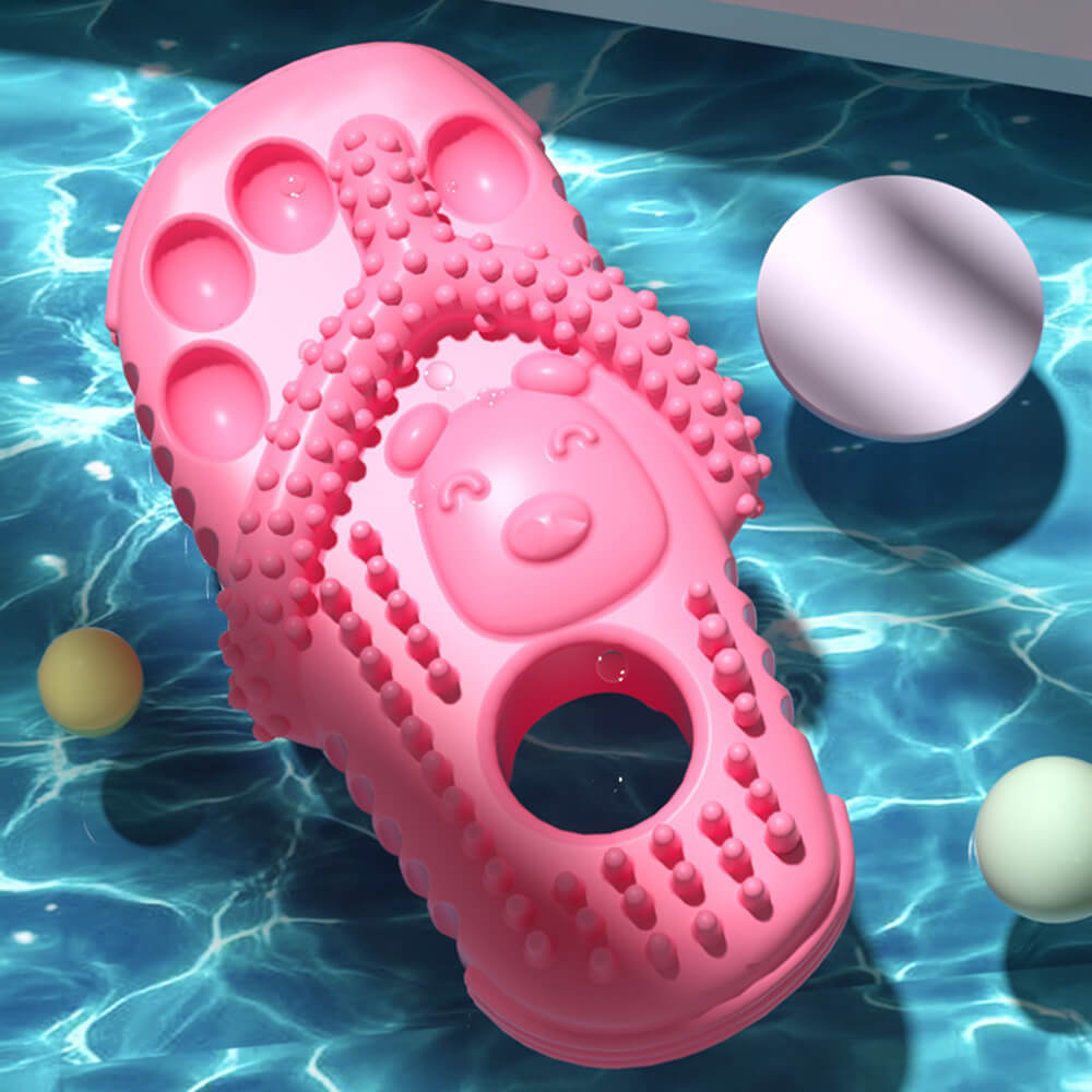 Rosa Hundekauspielzeug, wasserdicht, bissfest, Zahnpflege, schwimmend im Wasser.