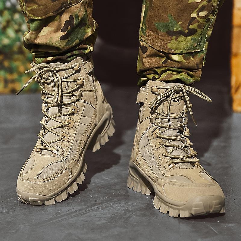 Bottes militaires beiges robustes avec lacets, portées avec un pantalon camouflage. Chaussures tactiques pour randonnée et activités extérieures.