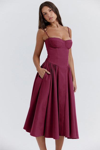 Robe midi bordeaux élégante avec bretelles fines, corsage ajusté et jupe évasée. Mode féminine chic, tenue de soirée tendance.