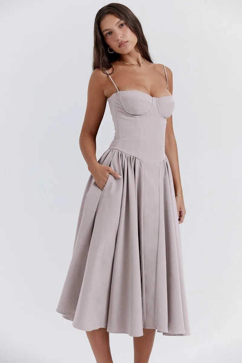 Robe élégante beige, bretelles fines, coupe évasée, portée par une femme. Mode féminine, style chic, tenue de soirée tendance.