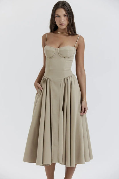 Robe beige élégante avec bretelles fines et jupe évasée, portée par une femme. Mode féminine chic, style classique, tenue de soirée.